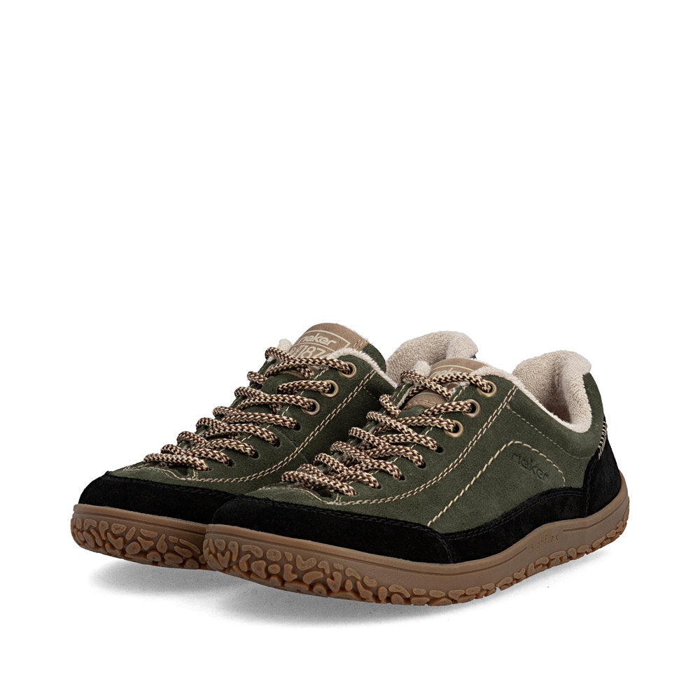 A pair of low-top winter sneakers in olive green suede and black fabric, featuring beige knit laces, a beige fleece lining, and a brown textured sole, shown against a plain white background.