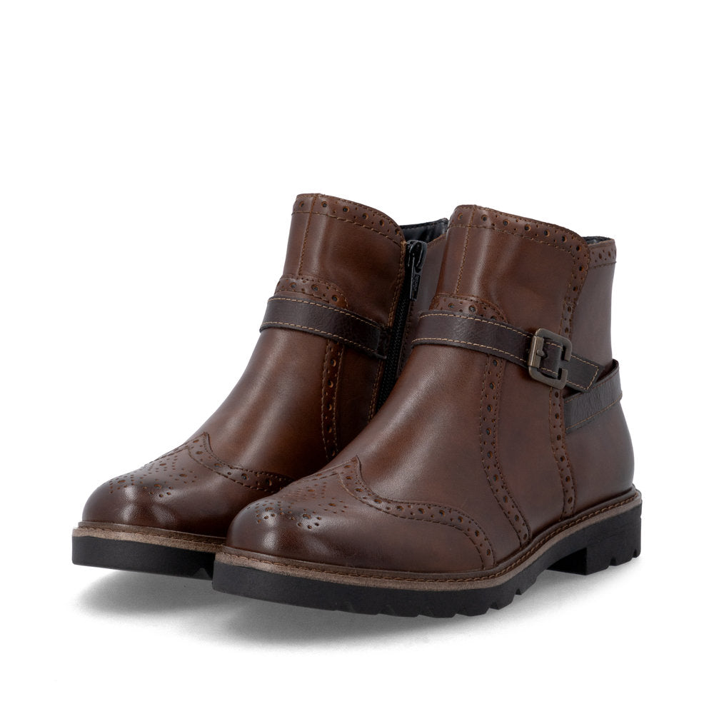 Pair of brown leather boots with buckles on a white background