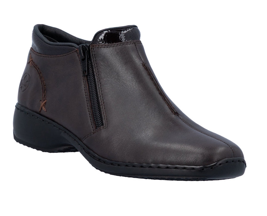 A dark brown leather ankle boot with a side zipper, low wedge heel, and a small brown embroidered logo on the heel, shown against a plain white background.