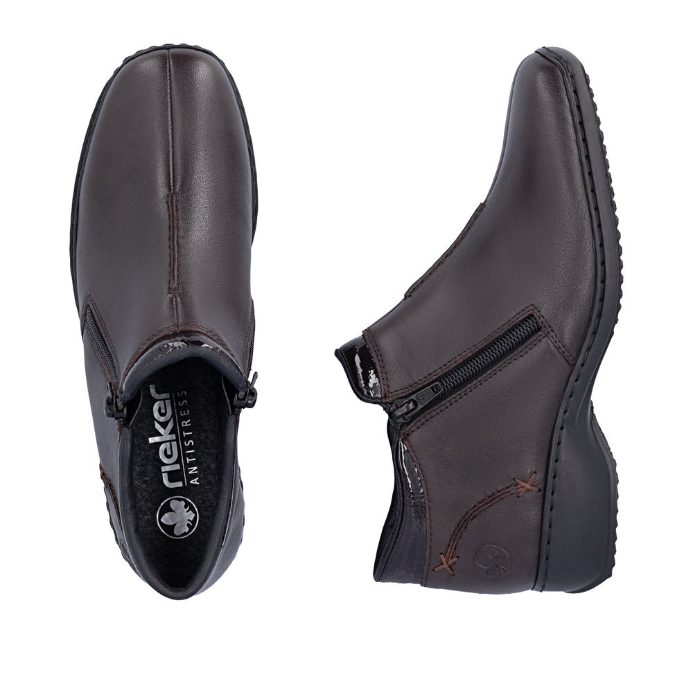 Pair of brown leather shoes with zippers on a white background