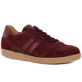 A low-top suede sneaker in deep burgundy with matching burgundy laces and a tan gum sole, shown from a three-quarters angle on a white background.